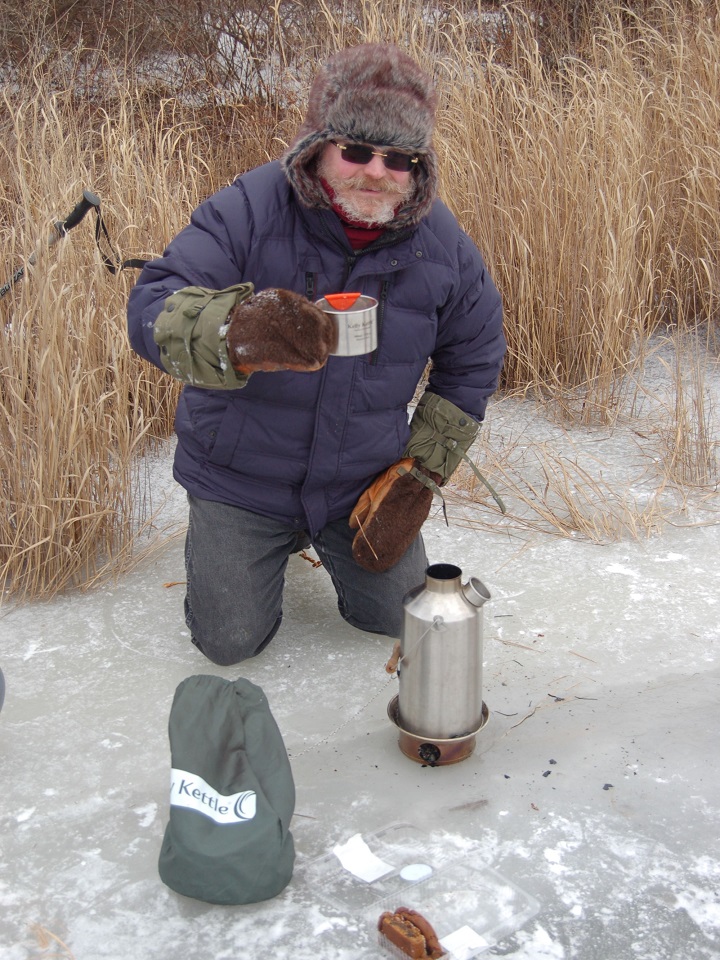 This is at the lake by our home. There was 14 inches of ice, and it was way below cold, about 0. But we all got warm and refreshed with our Kelly Kettle. The moral is, even with your home a few hundred yards home, using the Kettle is just fun, and a way to enjoy nature to the fullest.Thank you.