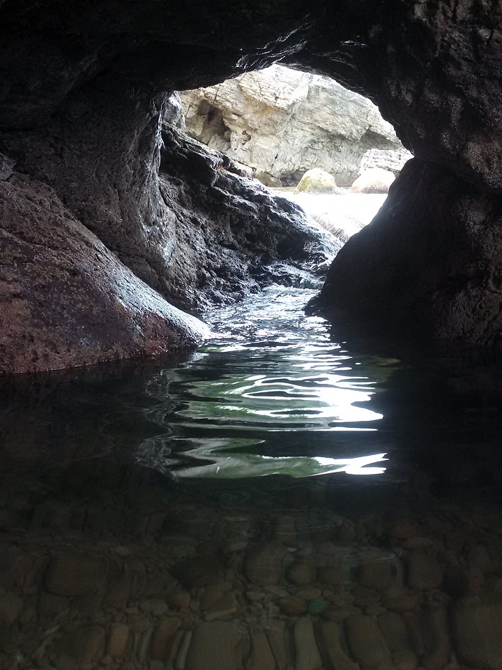 The Fairy Hole as it is known here in Cape Breton. It is a 3km hike to reach the beach. You must wade or swim the cold water of the Atlantic (depending on the tide), through the hole to access the grotto pool and the cave. Photo taken standing in the grotto pool looking back at the 