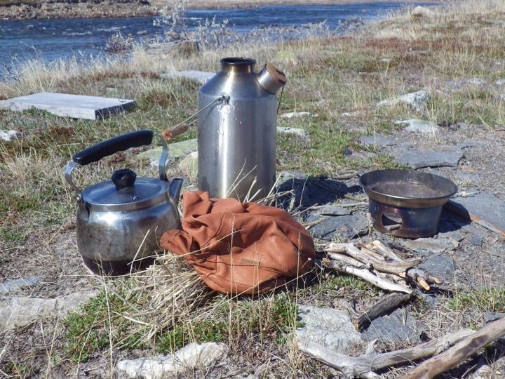 Flyfishing for arctic char at Diane River Nunavut in the Canadian Arctic. Tea time. Dry moss and dwarf willow for fuel. (Diane River Nunavut Canada)